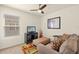 Comfortable sitting area featuring plush sofa, patterned ottoman, TV, and window at 5358 Shell Mound Cir, Punta Gorda, FL 33982