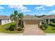 Charming home featuring a brick driveway, well-maintained landscaping, and a welcoming front entrance at 5358 Shell Mound Cir, Punta Gorda, FL 33982