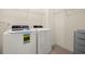 Functional laundry room with a washer and dryer set and shelving for storage at 5358 Shell Mound Cir, Punta Gorda, FL 33982