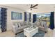 Cozy living room with plush gray seating, blue accent rug, and a view of the serene pond outside at 5358 Shell Mound Cir, Punta Gorda, FL 33982