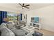 Inviting living room with comfortable seating, media center, and view overlooking a tranquil pond creating a relaxing space at 5358 Shell Mound Cir, Punta Gorda, FL 33982