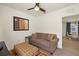 Cozy living room features a comfortable brown couch, stylish pillows, and modern artwork at 5358 Shell Mound Cir, Punta Gorda, FL 33982