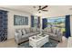 Cozy living room with plush gray seating, blue accent rug, and a view of the serene pond outside at 5358 Shell Mound Cir, Punta Gorda, FL 33982