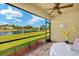 Inviting screened-in patio with outdoor seating and serene views of the pond and landscape at 5358 Shell Mound Cir, Punta Gorda, FL 33982