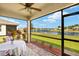 Relaxing screened patio with a table, seating, and beautiful views of the pond at 5358 Shell Mound Cir, Punta Gorda, FL 33982