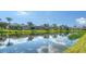 Beautiful backyard featuring a large pond and well-maintained landscaping at 5566 Avellino Pl, Sarasota, FL 34238