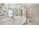 Bathroom featuring double sinks, a large mirror, and a walk-in shower at 5566 Avellino Pl, Sarasota, FL 34238