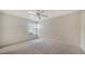 Bright bedroom featuring carpet, a ceiling fan, and a window letting in natural light at 5566 Avellino Pl, Sarasota, FL 34238