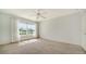 Bedroom features a large window, carpet flooring, and light blue walls at 5566 Avellino Pl, Sarasota, FL 34238