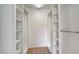 Walk-in closet with built-in shelving and carpeting at 5566 Avellino Pl, Sarasota, FL 34238
