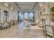 Bright clubhouse featuring a fireplace, high ceilings, large windows, and multiple seating areas at 5566 Avellino Pl, Sarasota, FL 34238