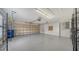 Spacious garage featuring a high ceiling, lots of storage, and an automatic garage door at 5566 Avellino Pl, Sarasota, FL 34238