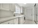Laundry room featuring a washer and dryer, lots of storage, and a sliding mirror door at 5566 Avellino Pl, Sarasota, FL 34238