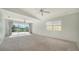Bright living room with vaulted ceiling, plush carpet, ceiling fans and sliding glass doors to the lanai at 5566 Avellino Pl, Sarasota, FL 34238