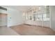 Spacious living room with carpet floors and built-in shelving for storage and display at 5566 Avellino Pl, Sarasota, FL 34238