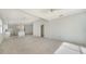 Bright and airy living room features carpet, ceiling fans, recessed lights, and open access to the kitchen at 5566 Avellino Pl, Sarasota, FL 34238