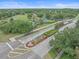 The image showcases a community entrance and surrounding greenery including sports courts at 5618 Sheer Bliss Loop, Land O Lakes, FL 34639