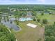 Beautiful aerial view of community amenities, including a pool, tennis courts, lake, and beach volleyball court at 5618 Sheer Bliss Loop, Land O Lakes, FL 34639