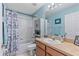 Cozy bathroom with blue walls, a shower and tub combination, and a classic vanity at 5618 Sheer Bliss Loop, Land O Lakes, FL 34639