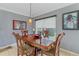 Traditional dining room with gray walls, wood table, lovely lighting, and stylish wall art at 5618 Sheer Bliss Loop, Land O Lakes, FL 34639