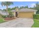 Inviting single-story home with a two-car garage, manicured landscaping, and a well-maintained lawn at 5618 Sheer Bliss Loop, Land O Lakes, FL 34639