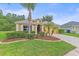 Inviting home featuring a well-maintained lawn, mature landscaping, and a two-car garage at 5618 Sheer Bliss Loop, Land O Lakes, FL 34639