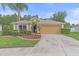 Charming home featuring a manicured lawn, mature landscaping, and a two-car garage at 5618 Sheer Bliss Loop, Land O Lakes, FL 34639