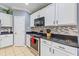 Efficient kitchen featuring a stainless steel oven and range, and granite countertops at 5618 Sheer Bliss Loop, Land O Lakes, FL 34639