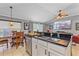 Open-concept kitchen with a granite countertop island, sink, and a view of the dining and living areas at 5618 Sheer Bliss Loop, Land O Lakes, FL 34639