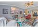 Inviting living room with a ceiling fan, vibrant wall art, and comfortable seating at 5618 Sheer Bliss Loop, Land O Lakes, FL 34639