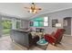 Comfortable living room features a ceiling fan, large windows, and cozy seating arrangement at 5618 Sheer Bliss Loop, Land O Lakes, FL 34639