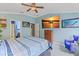 Comfortable main bedroom offers a ceiling fan, mounted TV, dresser and convenient ensuite bathroom at 5618 Sheer Bliss Loop, Land O Lakes, FL 34639