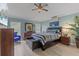 Light and airy main bedroom with furniture and decor in neutral tones, ceiling fan, and exterior views at 5618 Sheer Bliss Loop, Land O Lakes, FL 34639