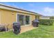 Patio with grills, outdoor furniture, and sliding glass doors providing easy access to the backyard at 5618 Sheer Bliss Loop, Land O Lakes, FL 34639
