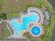Aerial shot of the pool showcasing its unique shape and luxurious poolside lounge chairs at 5618 Sheer Bliss Loop, Land O Lakes, FL 34639