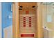 Inside view of the indoor sauna, with wooden benches and red accents, located inside the primary bathroom at 5618 Sheer Bliss Loop, Land O Lakes, FL 34639