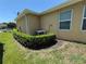 Backyard with well-maintained lawn and landscaping around the home's exterior at 6121 35Th E Ct, Bradenton, FL 34203