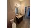 A bathroom with tile flooring, a toilet, vanity, and an Eiffel Tower decoration at 6121 35Th E Ct, Bradenton, FL 34203