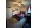 Cozy bedroom featuring modern carpet, ceiling fan, and built-in storage at 6121 35Th E Ct, Bradenton, FL 34203