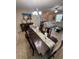 Formal dining room with dark wood table, decorative runner, and stylish chandelier lighting at 6121 35Th E Ct, Bradenton, FL 34203