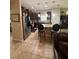 Charming kitchen featuring an island, stainless steel appliances, and a cozy breakfast bar at 6121 35Th E Ct, Bradenton, FL 34203