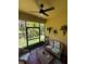Screened-in lanai with cozy seating and ceiling fan providing the perfect spot for relaxation and enjoying the outdoors at 6121 35Th E Ct, Bradenton, FL 34203