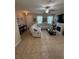 Inviting living room featuring a sectional couch, tile flooring, and a cozy fireplace at 6121 35Th E Ct, Bradenton, FL 34203