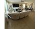 Bright living room with a comfortable sectional, fireplace, and adjoining dining area at 6121 35Th E Ct, Bradenton, FL 34203