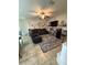 Comfortable living room featuring a large sectional sofa, ceiling fan, and wall decor accents at 6121 35Th E Ct, Bradenton, FL 34203