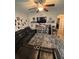Inviting living room features a plush sectional sofa, ceiling fan, and a decorative display shelf for a cozy atmosphere at 6121 35Th E Ct, Bradenton, FL 34203