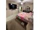 Spacious bedroom features a ceiling fan and TV, with an ensuite bathroom and comfortable carpet at 6121 35Th E Ct, Bradenton, FL 34203