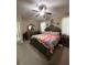 Neutral Primary bedroom featuring carpet, a ceiling fan, and access to an ensuite bathroom at 6121 35Th E Ct, Bradenton, FL 34203