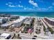 Gorgeous aerial view of the beachfront condominium with an American flag in the foreground at 6512 Midnight Pass Rd # 301, Sarasota, FL 34242