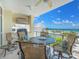 Inviting balcony with a grill, seating, and beautiful ocean views for outdoor dining and relaxation at 6512 Midnight Pass Rd # 301, Sarasota, FL 34242